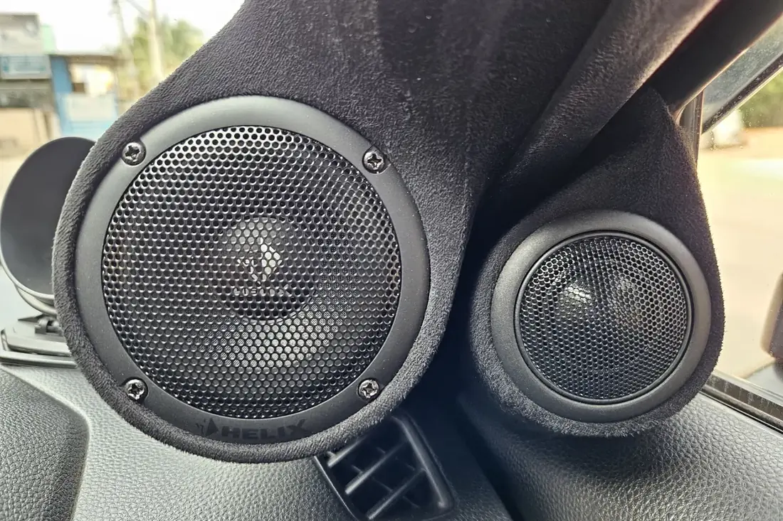 A fabricated A-pillar pod holding a midrange driver and a tweeter, trimmed to match the interior